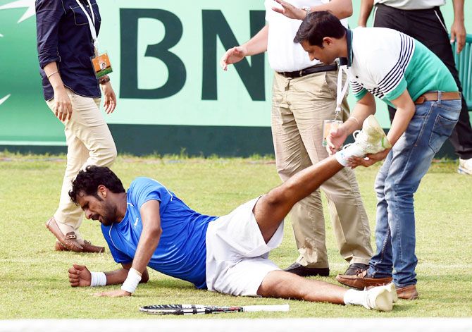 India's Saketh Myneni receives treatment after sustaining an injury during his Davis Cup singles match against Korea's Yong- Kyu Lim at the Asia/Oceania Group-I tie at Chandigarh on Friday