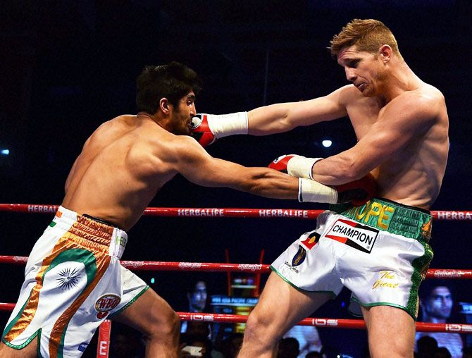 Boxer Vijender Singh lands a punch on opponent Kerry Hope during their WBO Asia Pacific Middleweight Championship at Thyagaraj Sports Complex in New Delhi on Saturday