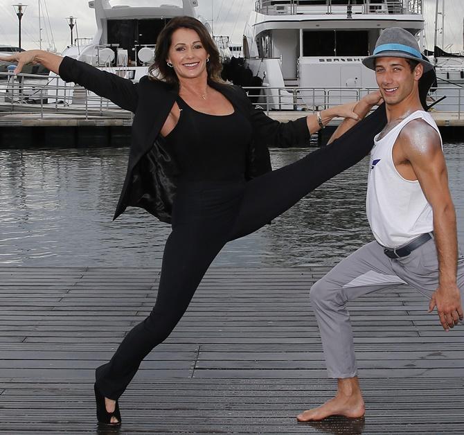 Olympian gymnastics star Nadia Comaneci, left, poses during a photocall