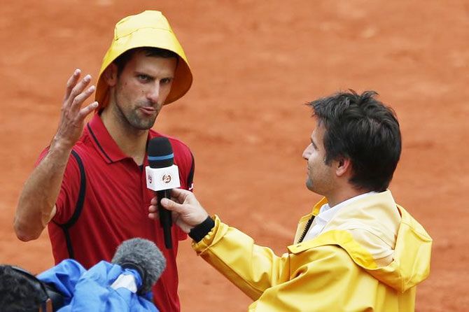 A jestful Novak Djokovic answers questions by former French tennis player Arnaud Clement after his win over Roberto Bautista Agut on Wednesday