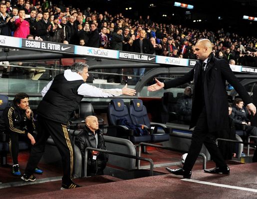 Pep Guardiola (right) greets Jose Mourinho before a match