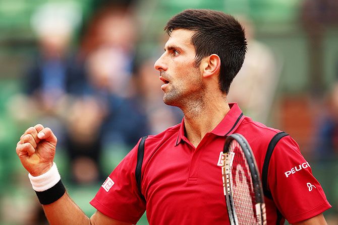 Novaj Djokovic celebrates after winning his French Open fourth round match against Roberto Bautista Agut at Roland Garros on Wednesday