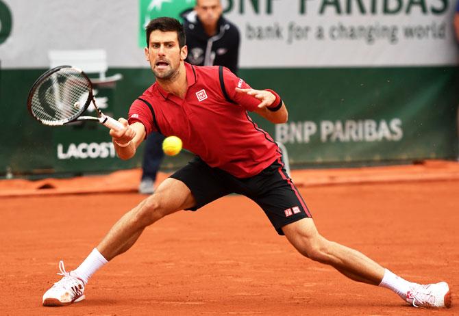 Serbia's Novak Djokovic hits a forehand against Czech Republic's Tomas Berdych 