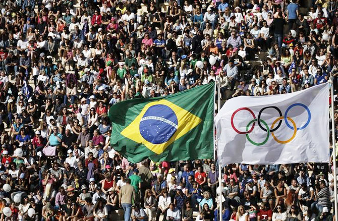 The Brazilian and Olympic flags fly over the Panathenaic Stadium during the handover ceremony of the Olympic Flame to the delegation of the 2016 Rio Olympics, in Athens, Greece, on April 27, 2016