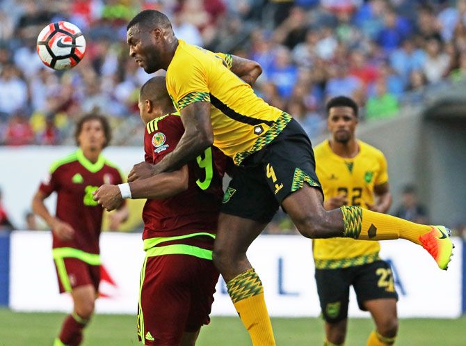 Jamaica's Wes Morgan heads the ball over Venezuela's Jose Salomon Rondon