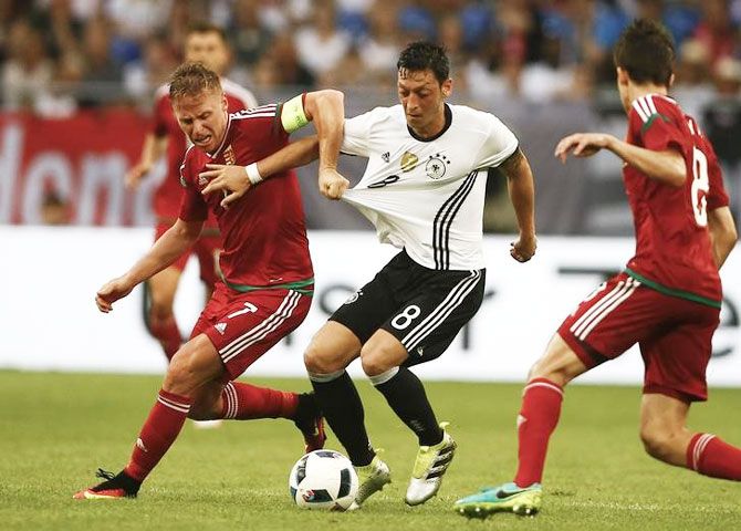 Germany's Mesut Oezil and Hungary's Balasz Dzsudszak vie for possession during their international friendly on Saturday. Expectations are high that Ozil will come good and help the German to the Euro title this year