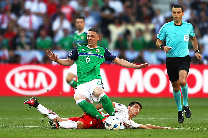 Poland's Bartosz Kapustka fouls Northern Ireland's Chris Baird resulting in a yellow card