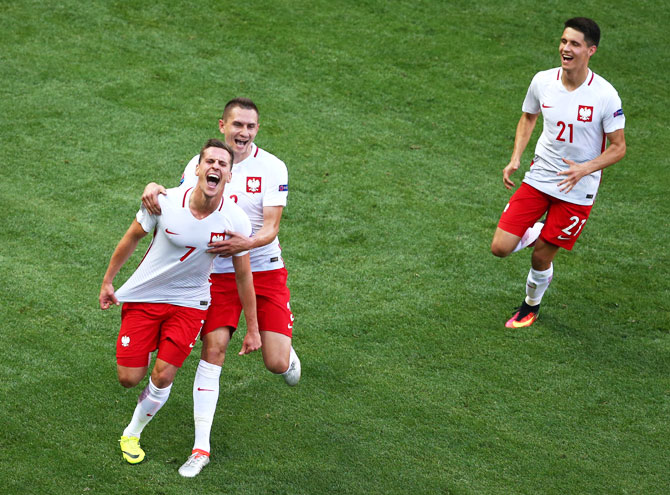 Poland's Arkadiusz Milik (left) celebrates with teammates Artur Jedrzejczyk (centre) and Bartosz Kapustka (right) after scoring against Northern Ireland during their Euro 2016 Group C match at Allianz Riviera Stadium in Nice, on Sunday