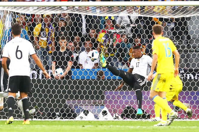 Germany's Jerome Boateng  clears the ball off the goal line to deny Ukraine