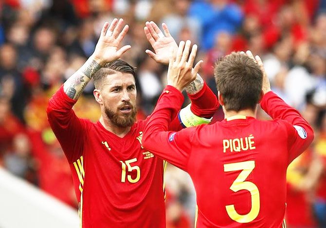  Spain's Gerard Pique and Sergio Ramos celebrate at the end of their match against Czech Republic on Monday
