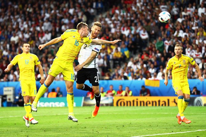 Germany's Shkodran Mustafi heads the ball to score his team's first goal against Ukraine during their Euro 2016 Group C match at Stade Pierre-Mauroy in Lille on Sunday