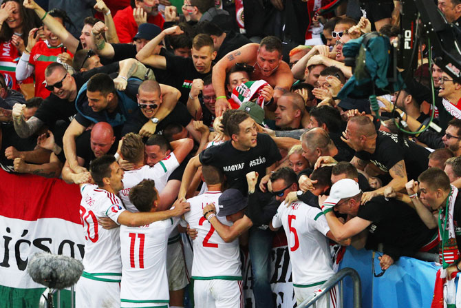 Hungary players celebrate their team's first goal with supporters during the UEFA EURO 2016 Group F match against Austria at Stade Matmut Atlantique Bordeaux on June 14