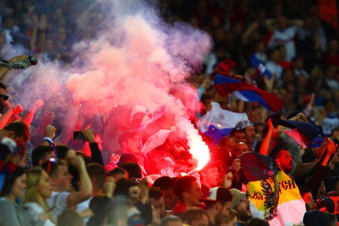 Russia supporters set off a red flare during the Euro 2016 Group B match between Russia and Slovakia at Stade Pierre-Mauroy in Lille on Wednesday