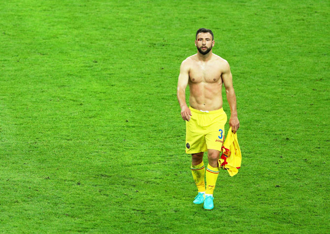 Romania's Razvan Rat walks off the pitch