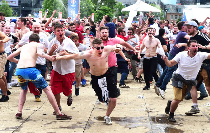 England fans celebrate at the Fanzone in Lille after Raheem Sterling netted England's late winner