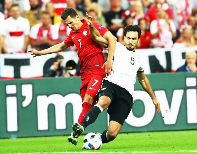 Poland's Arkadiusz Milik and Germany's Mats Hummels compete for the ball during their Euro 2016 Group C match at Stade de France in Paris on Thursday