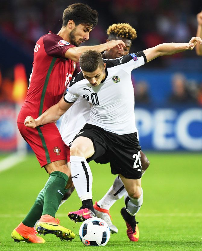 Austria's David Alaba and Marcel Sabitzer hold off Portugal's Andre Gomes