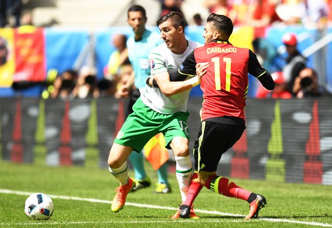 Republic of Ireland's Stephen Ward and Belgium's Yannick Carrasco compete for the ball