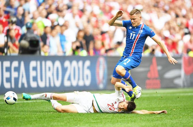 Hungary's Richard Guzmics tackles Iceland's Alfred Finnbogason