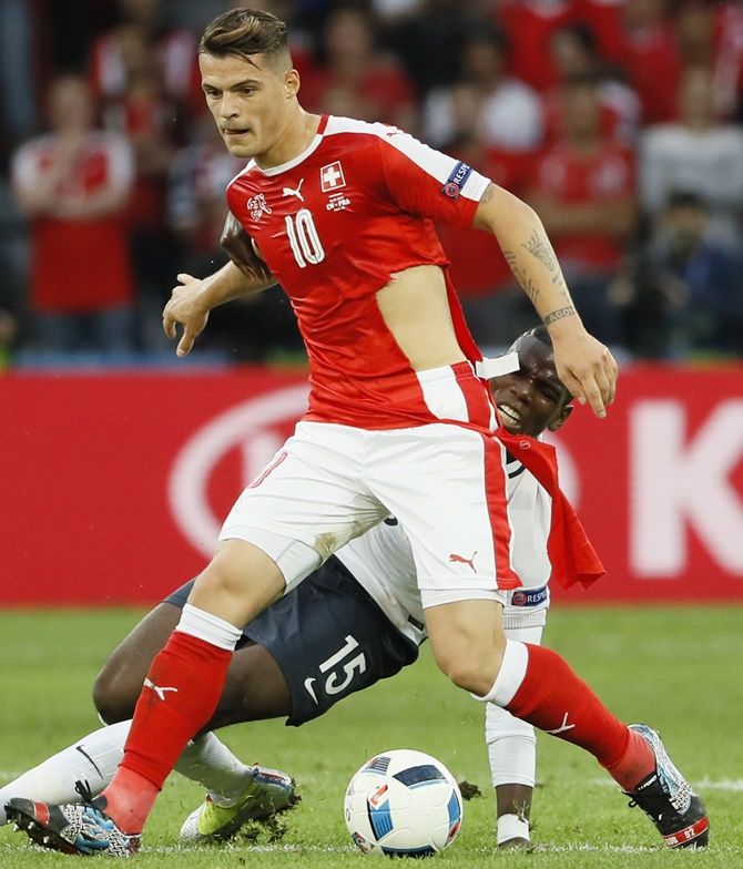  Switzerland's Granit Xhaka has his shirt ripped after a challenge by France's Paul Pogba during their Euro match