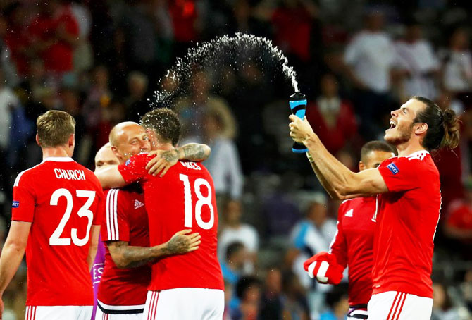 Wales captain Gareth Bale (right) and teammates celebrate victory over Russia on Monday