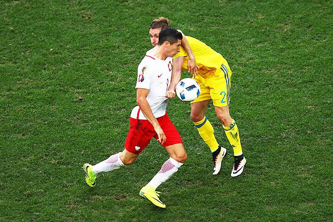 Poland's Robert Lewandowski is tackled by Ukraine's Bohdan Butko