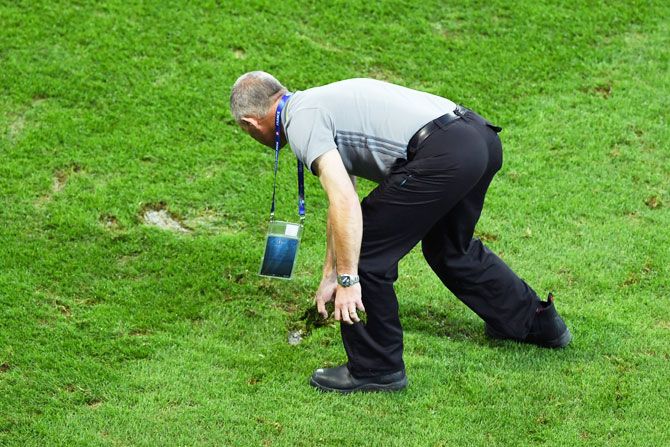 Ground staff tends the pitch at the half time during the UEFA Euro 2016 Group A match between Switzerland and France at Stade Pierre-Mauroy in Lille, France, on Sunday