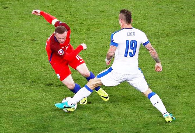 Slovakia's Juraj Kucko (right) challenges England's Wayne Rooney