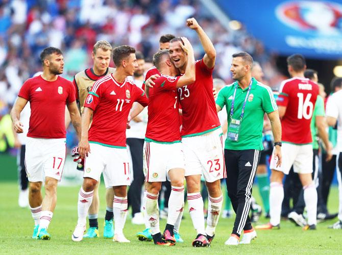 Hungary's Roland Juhasz (right) and Balazs Dzsudzsak (left) celebate topping Group F and going through to the knock-out stage after their 3-3 draw with Portugal