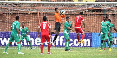 Salgaocar players, in green, defend during a match against Shillong Lajong