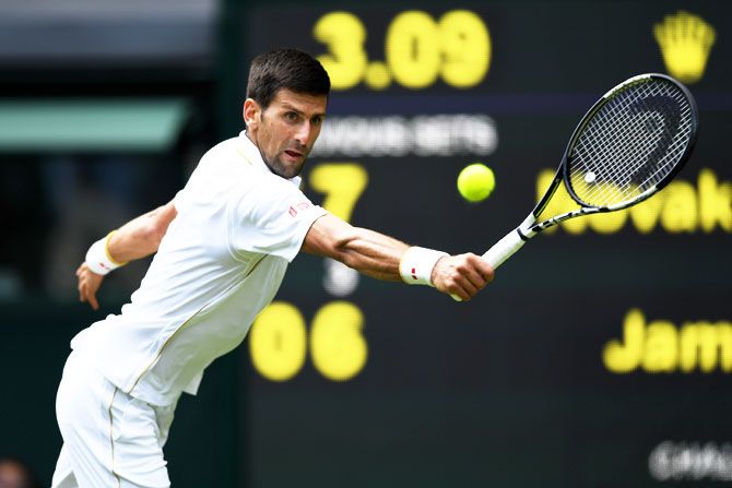 Serbia's Novak Djokovic plays a backhand shot during his Wimbledon first round match against England's James Ward at the All England Lawn Tennis and Croquet Club in London on Monday