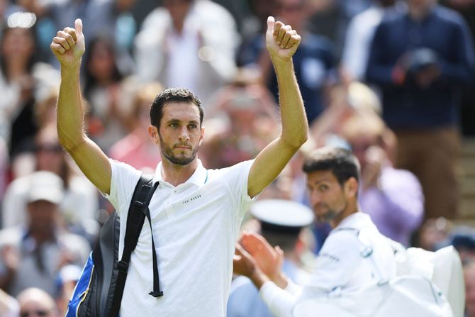 James Ward applauds supporters following his defeat against Novak Djokovic