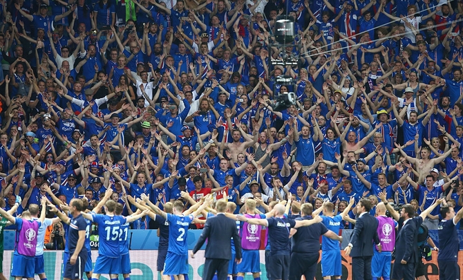 Iceland players and supporters celebrate their team's 2-1 win against England