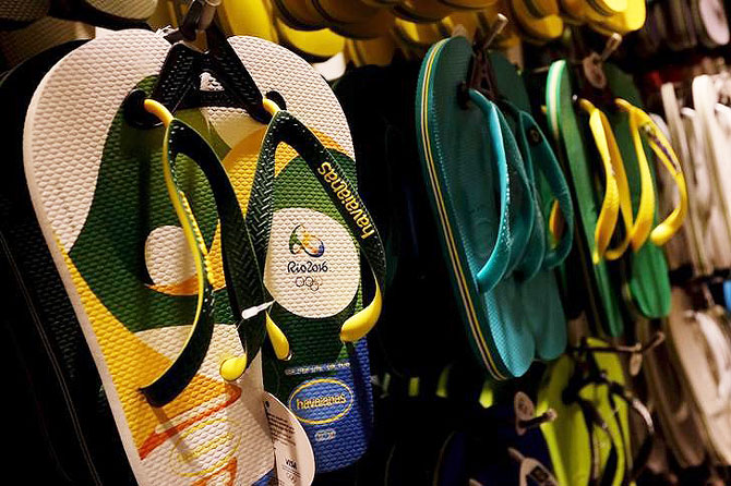 The official logo of the Rio summer Olympic 2016 games is seen on a pair of flip flops at a shop in Sao Paulo