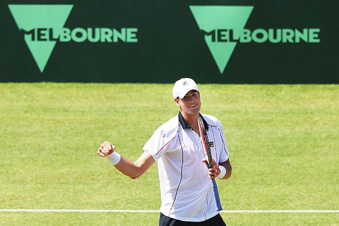 USA's John Isner celebrates winning match point in his match against Australia's Bernard Tomic during their Davis Cup tie at Kooyong in Melbourne on Sunday