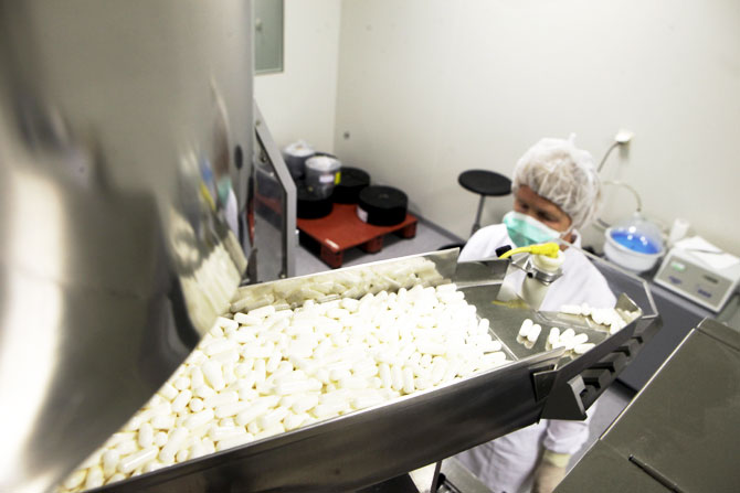 A manufacturing operator works at the Mildronate (Meldonium) medication packaging process in the production plant of the Grindeks pharmaceutical company in Riga, Latvia