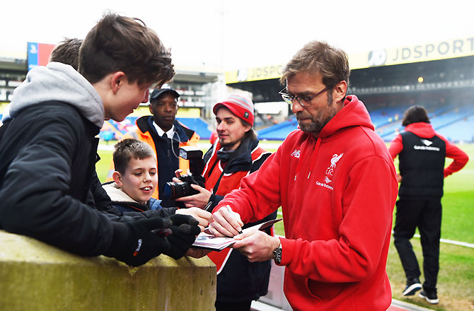 Liverpool manager Jurgen Klopp signs autographs