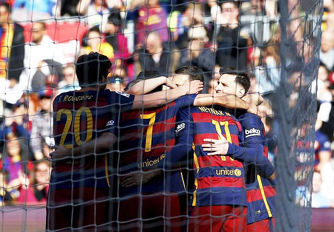 Barcelona's players celebrate a goal against Getafe during their La Liga match at camp Nou in Barcelona on Saturday