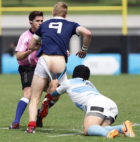 Conil Ignacio of Argentina pulls down Faraj Fartass of France during the Rugby Sevens final on day four of the Nanjing 2014 Summer Youth Olympic Games at the Olympic Sports Park