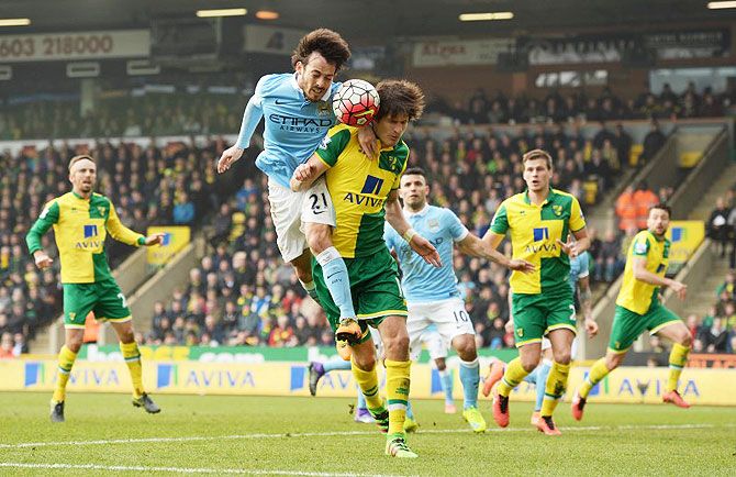 Manchester City's David Silva and Norwich City's Timm Klose clash as they vie for posession