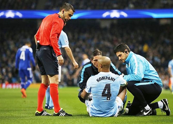 Manchester City's Vincent Kompany receives treatment after sustaining an injury