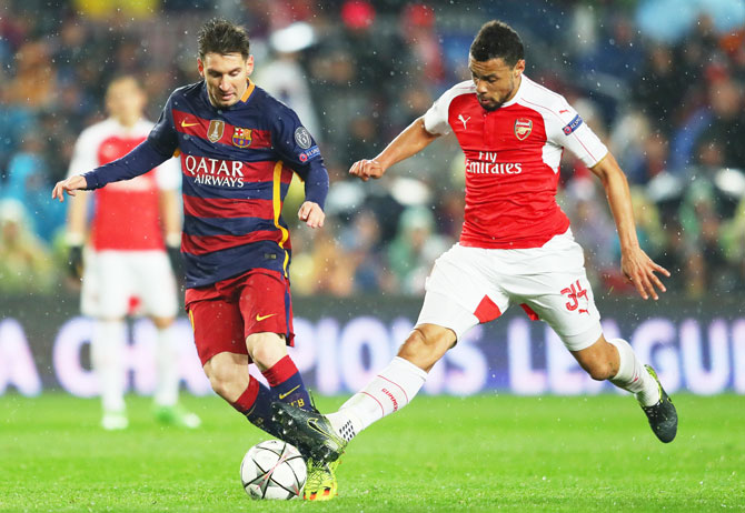 Barcelona's Lionel Messi and Arsenal's Francis Coquelin vie for the ball