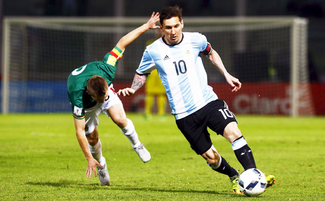 Argentina's Lionel Messi outruns a Bolivia player