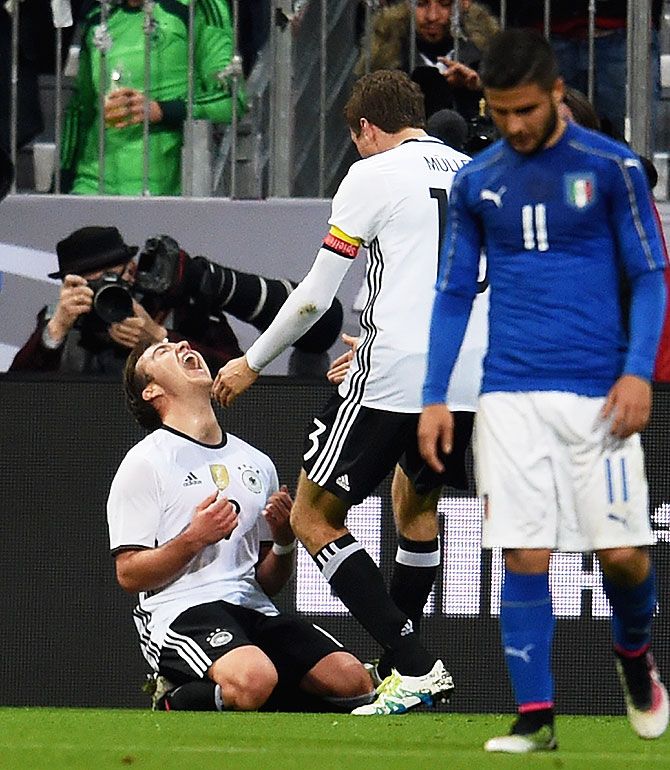 Germany's Mario Gotze (left) celebrates after scoring the second goal against Italy at Allianz Arena in Munich on Tuesday