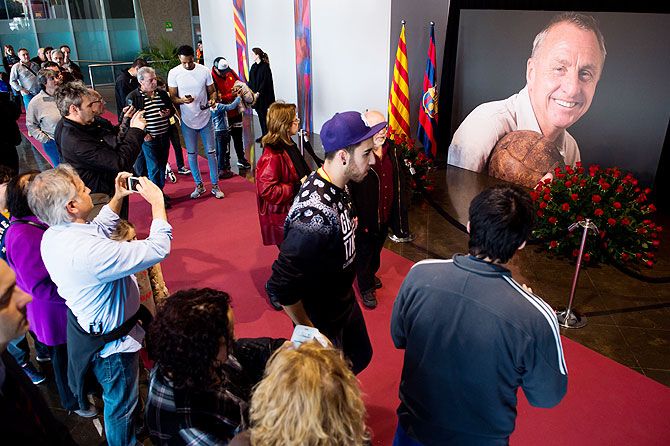 Visitors and fans queue to pay tribute to late Dutch football star Johan Cruyff in a special condolence area set up at Camp Nou stadium