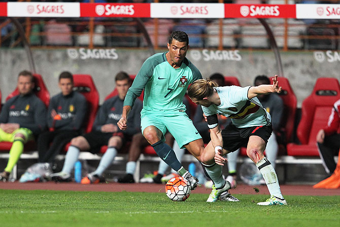 Portuguese forward Cristiano Ronaldo (left) vies with Belgium midfielder Guillaume Gillet