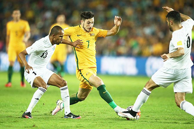 Australia's Mathew Leckie contests for the ball with Jordan's Yaseen Al-Bakhit and Ehsan Haddad during the 2018 FIFA World Cup qualifier at Allianz Stadium in Sydney on Tuesday