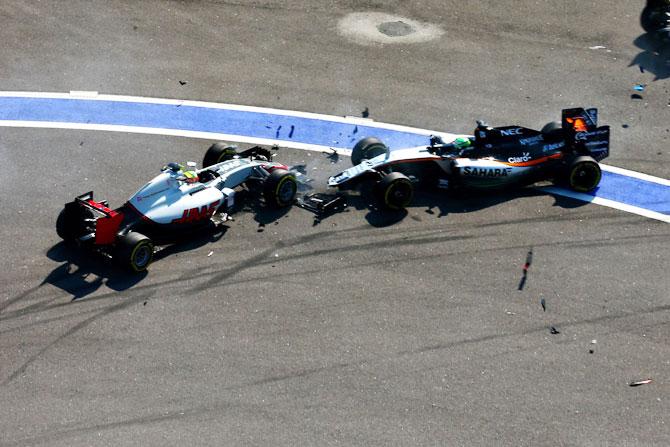   Sahara Force India F1 Team's German drive Nico Hulkenberg drivingf the VJM09 Mercedes PU106C Hybrid turbo and Haas F1 Team's Mexican driver Esteban Gutierrez in the Haas-Ferrari VF-16 Ferrari 059/5 turbo collide at the start during the Formula One Grand Prix of Russia at Sochi Autodrom in Sochi, Russia, on Monday