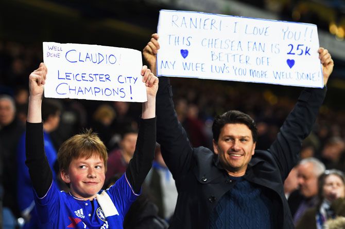 Chelsea fans hold up banners celebrating Leicester City's title triumph after Chelsea and Tottenham's 2-2 draw on Monday