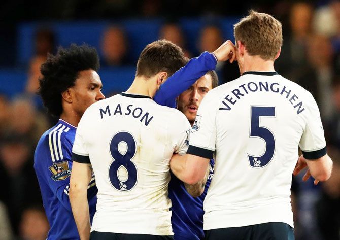 Tottenham's Ryan Mason clashes with Chelsea's Eden Hazard 